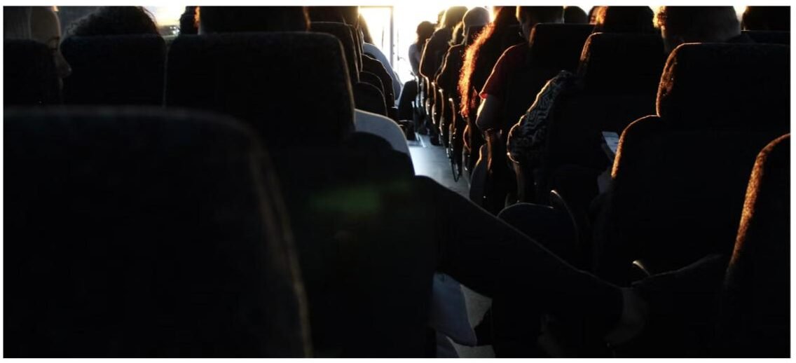 Reclining high-back seats inside a charter bus used for team travel